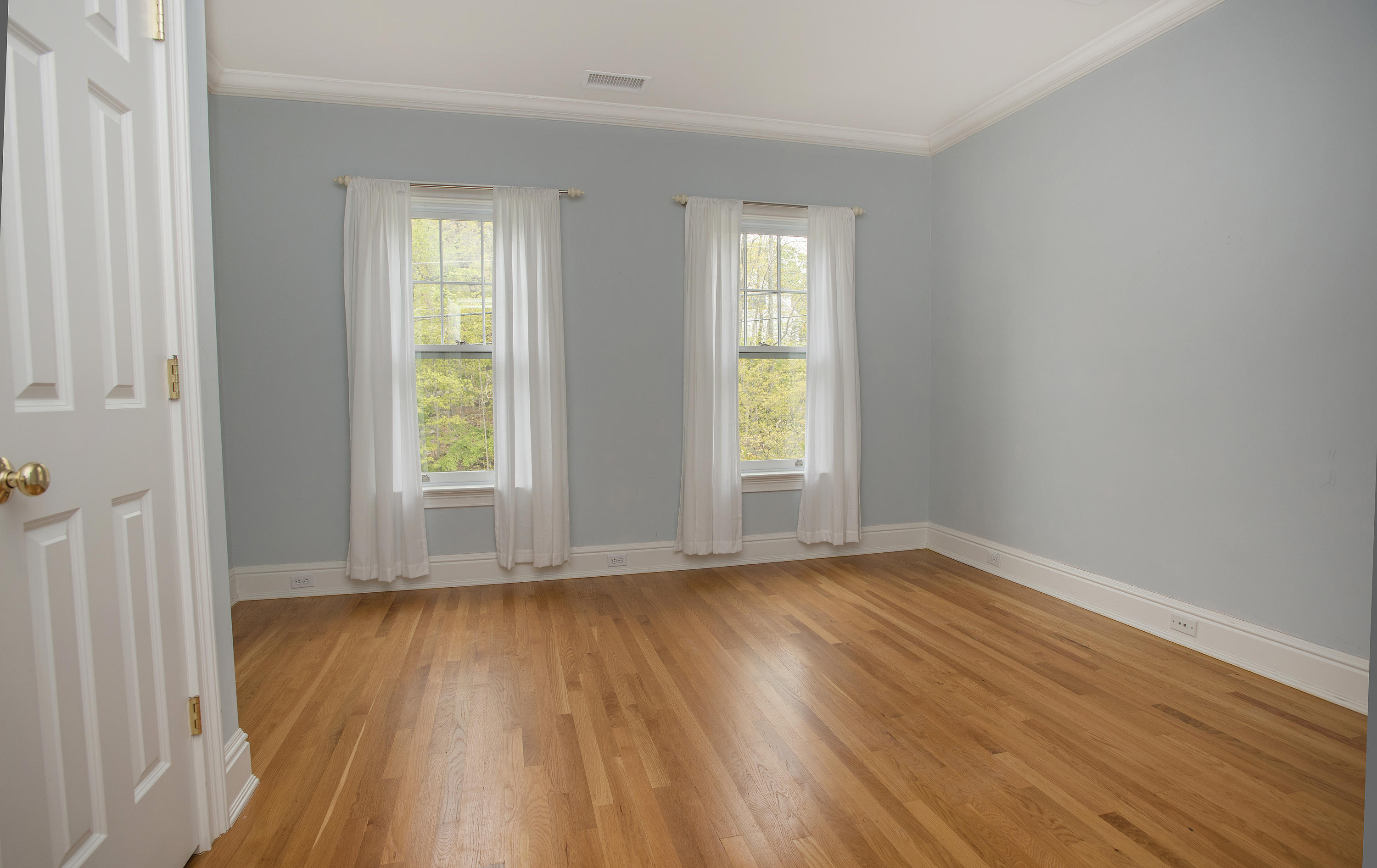 17 Brushy Ridge Road New Canaan, CT 06840 - Photo 17 of 35 an empty room with wooden floor and windows