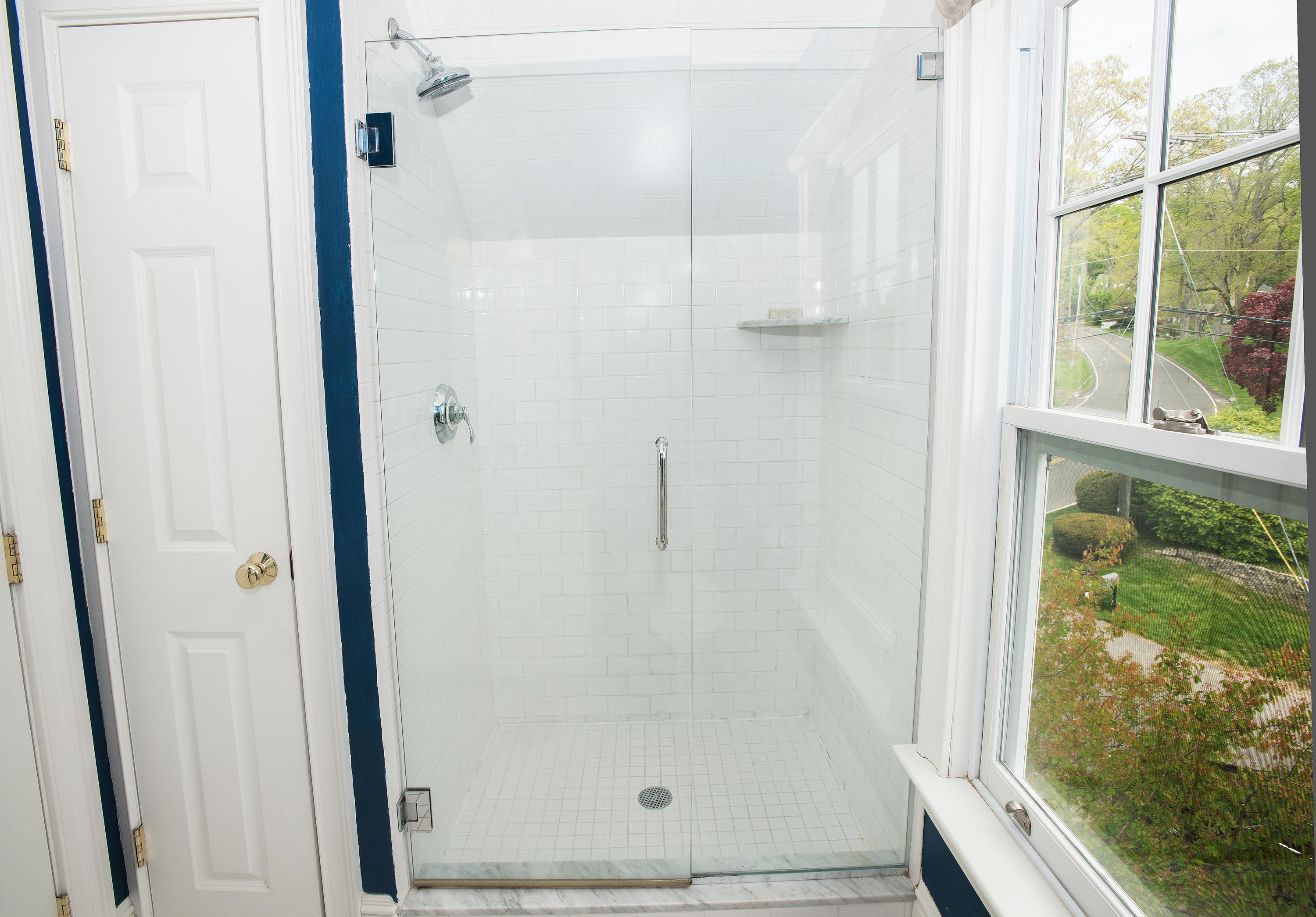 17 Brushy Ridge Road New Canaan, CT 06840 - Photo 26 of 35 a bathroom with a glass shower door