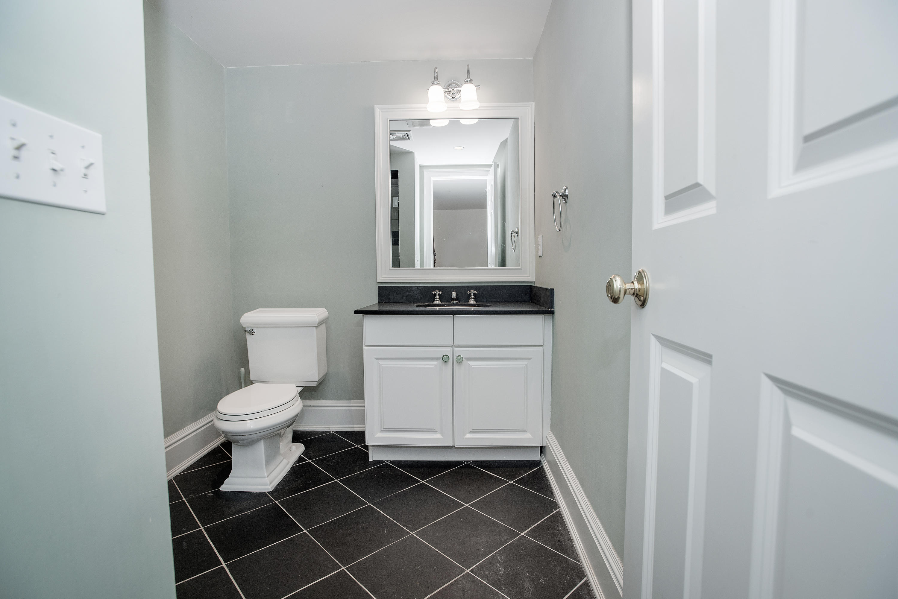 17 Brushy Ridge Road New Canaan, CT 06840 - Photo 29 of 35 a bathroom with a toilet a sink and a mirror