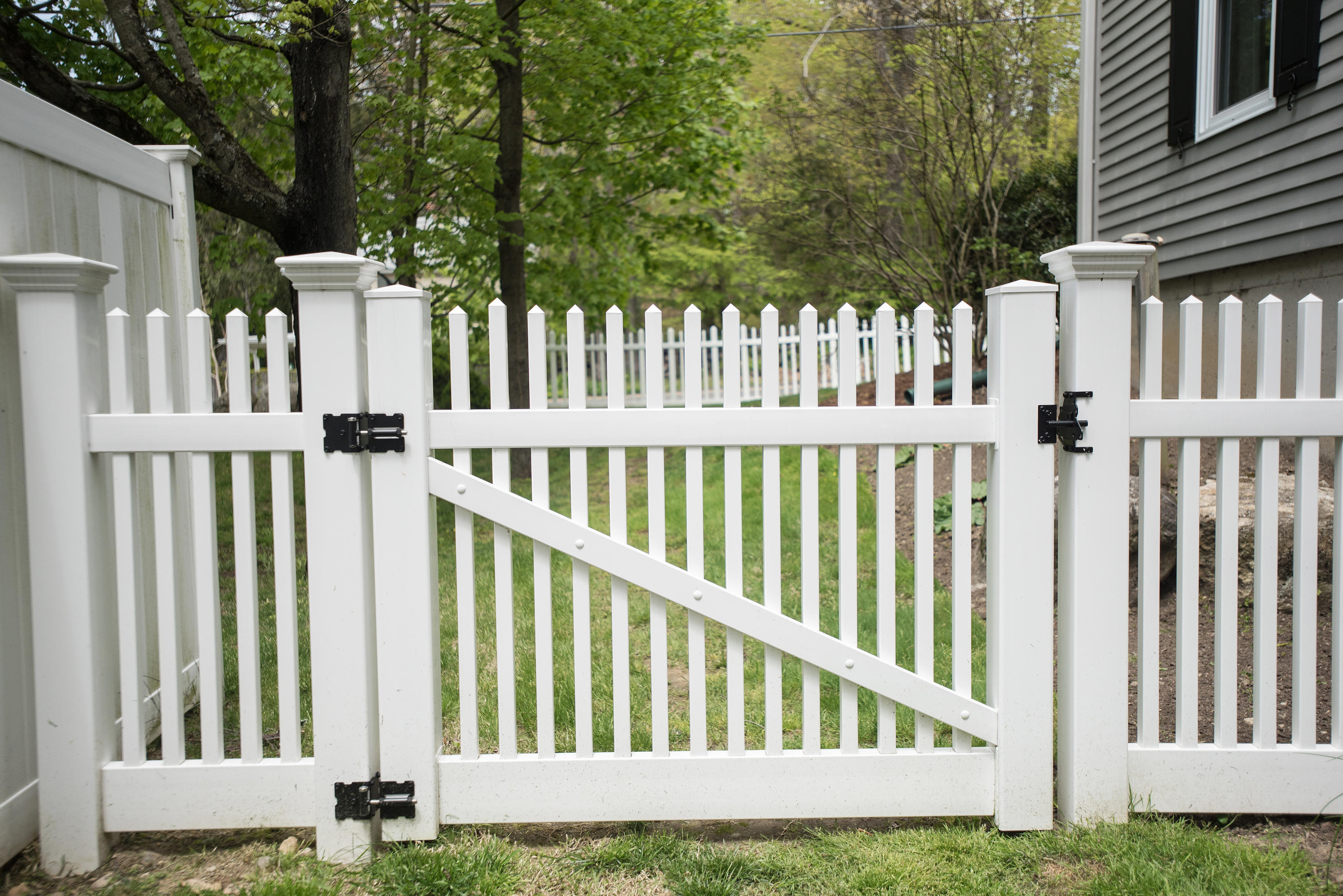 17 Brushy Ridge Road New Canaan, CT 06840 - Photo 32 of 35 a view of a white house with a small yard and wooden fence