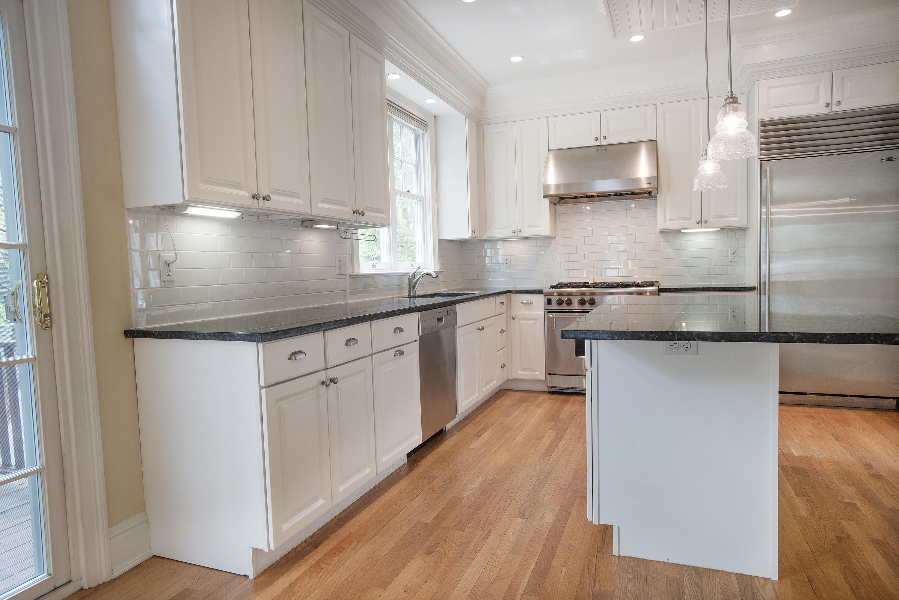 17 Brushy Ridge Road New Canaan, CT 06840 - Photo 8 of 35 a kitchen with stainless steel appliances granite countertop a sink a stove and a refrigerator