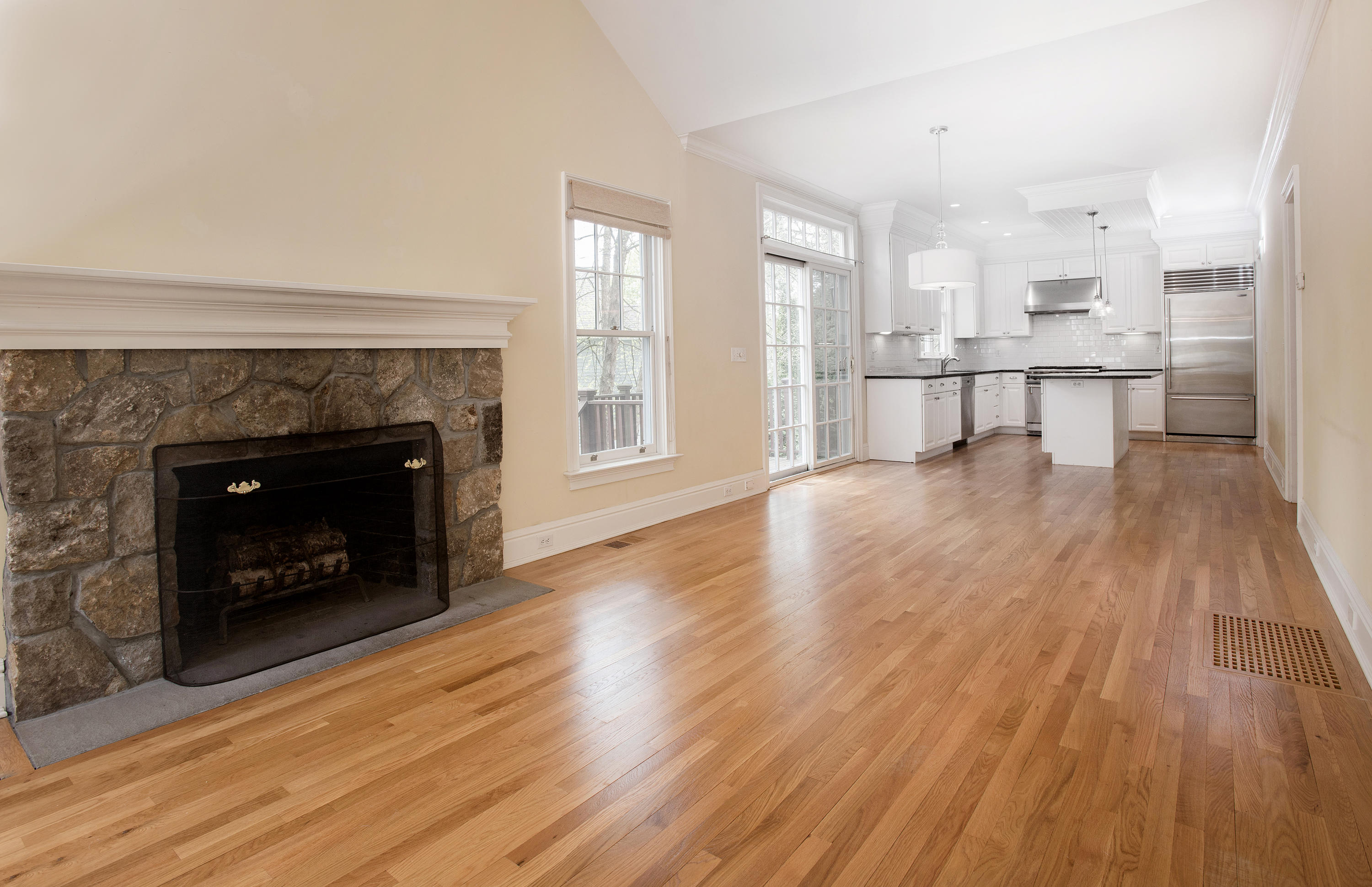 17 Brushy Ridge Road New Canaan, CT 06840 - Photo 10 of 35 a living room with stainless steel appliances wooden floor and a fireplace