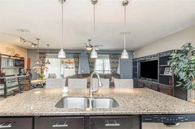 a kitchen with sink a counter and kitchen view
