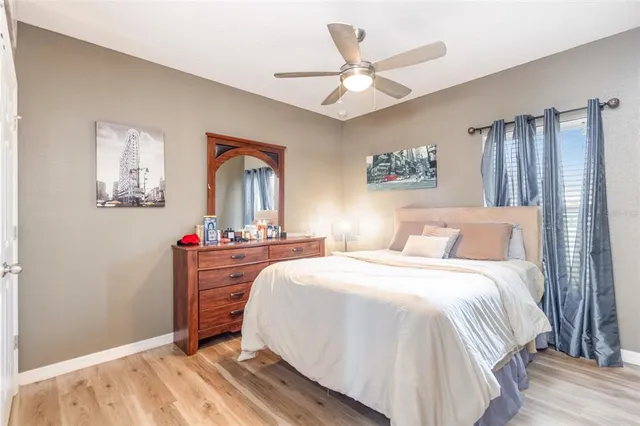 a bedroom with a large bed and a chandelier