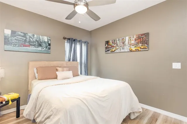 a bedroom with a large bed and a chandelier