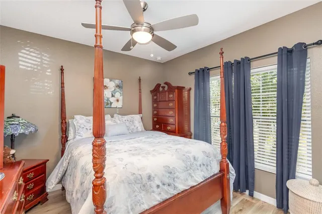 a bed room with a bed mirror and a window