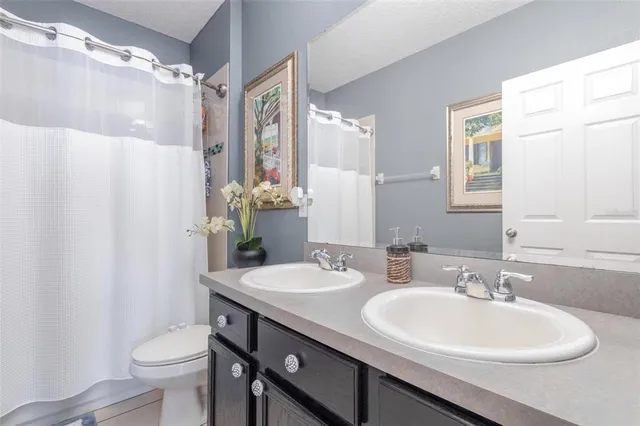 a bathroom with a sink toilet and a mirror
