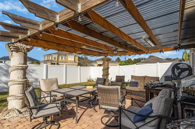 a view of a patio with table and chairs