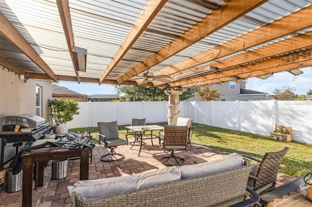 a view of a patio with table and chairs and couches