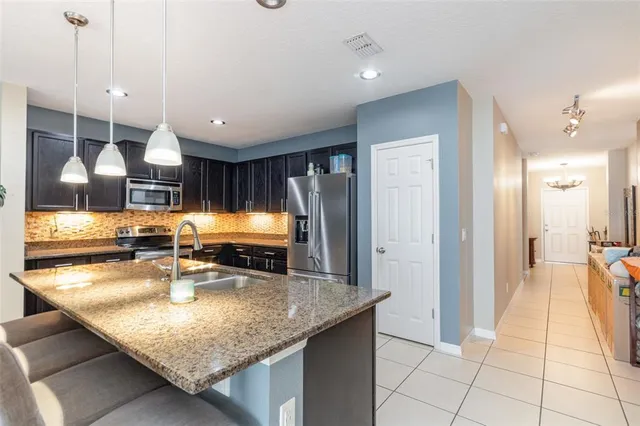 a kitchen with stainless steel appliances granite countertop a sink counter space and cabinets