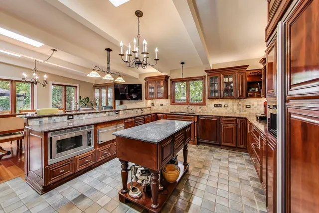 a view of a dining room with furniture and chandelier