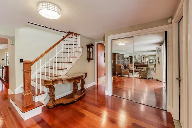 a view of a living room and dining room with wooden floor