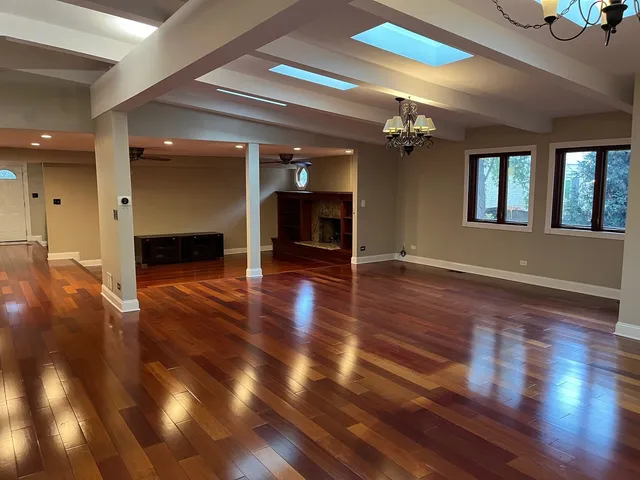 a living room with stainless steel appliances furniture and a kitchen view