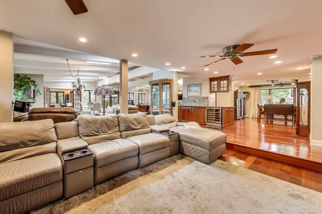 a view of a hallway with furniture and wooden floor