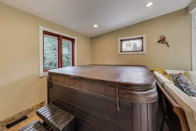 a bedroom with a large bed and a chandelier