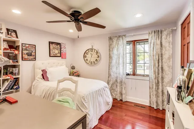 a view of a house with a big yard and large trees