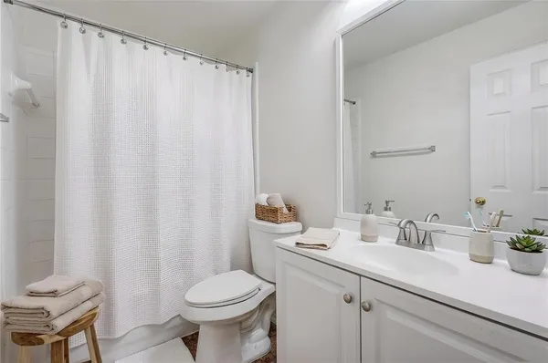 a bathroom with a sink a toilet and a mirror