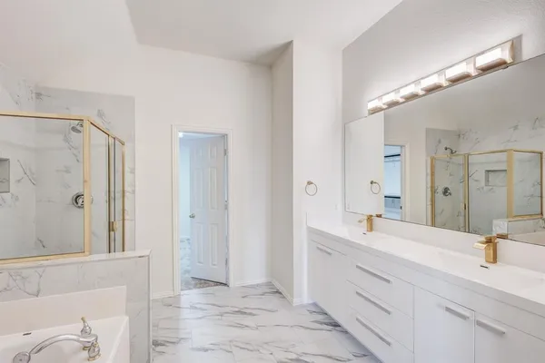 a bathroom with a double vanity sink mirror and shower