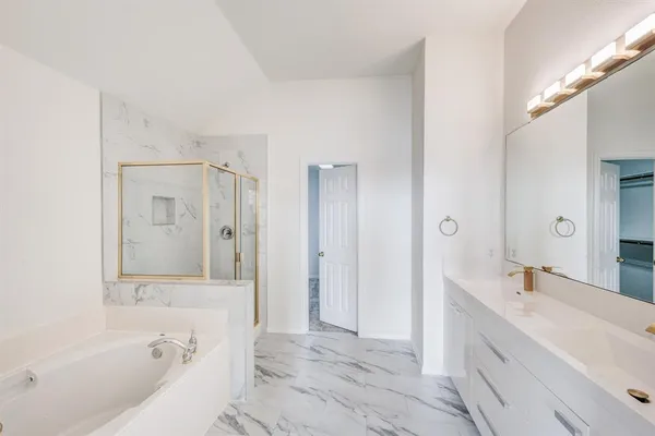a bathroom with a bathtub shower and a sink