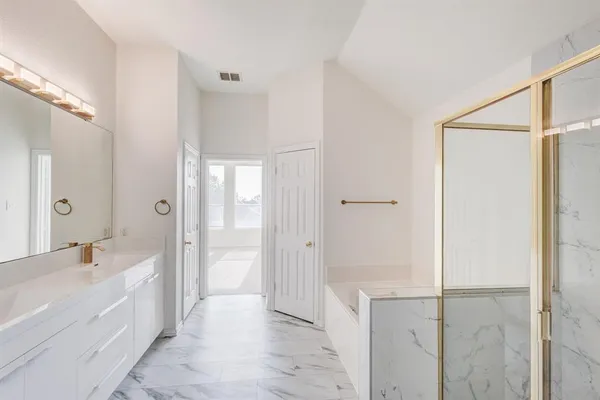 a bathroom with a bathtub shower and a sink