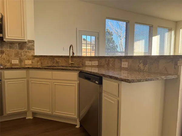 a kitchen with stainless steel appliances granite countertop a sink and a granite counter tops