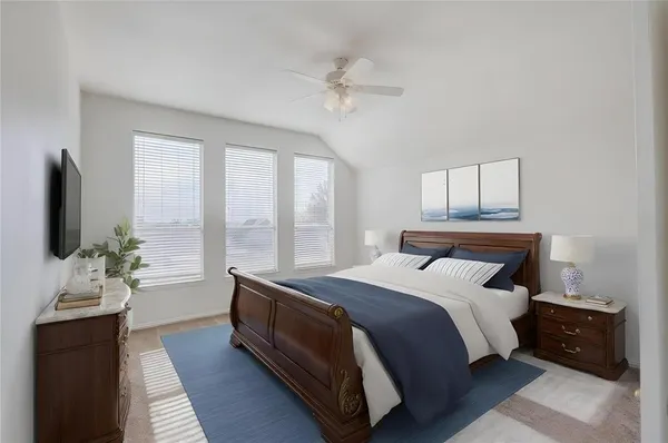 a bedroom with a large bed and a flat tv screen on a dresser