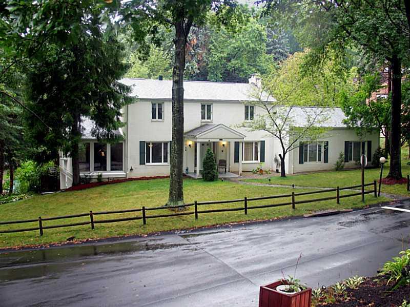 Exterior Front. 4 bedrooms, 2 full baths, 3 partial baths, 2-car garage, pool house, greenhouse, sauna, corner lot!