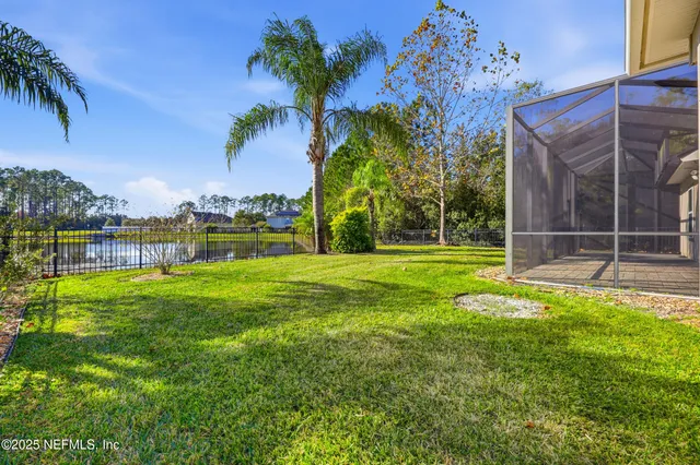 a front view of a house with a garden and trees