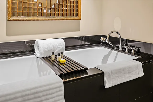 a close view of a sink a counter and chair in a room