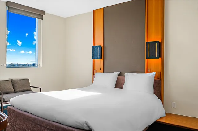 a bedroom with a bed and lamp