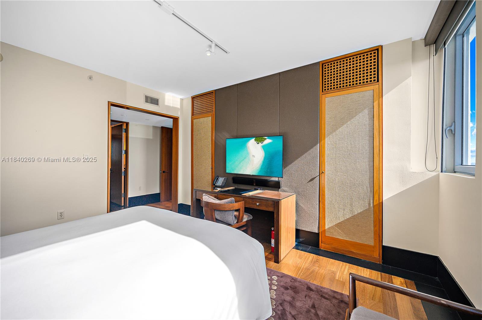 101 20th Street, Unit 3504 Miami Beach, FL 33139 - Photo 17 of 25 a bedroom with a bed and wooden floor