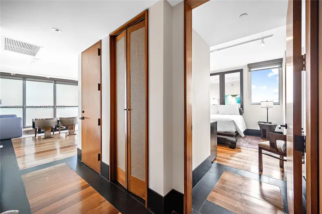 a en suite bathroom with sink a mirror and a large window