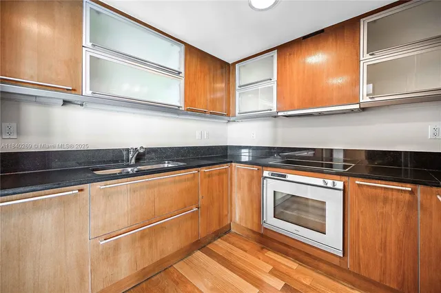 a kitchen with stainless steel appliances granite countertop a sink stove and microwave