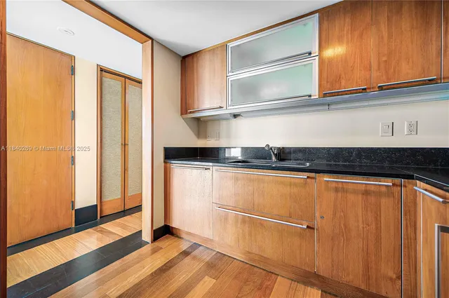 a kitchen with a refrigerator and cabinets