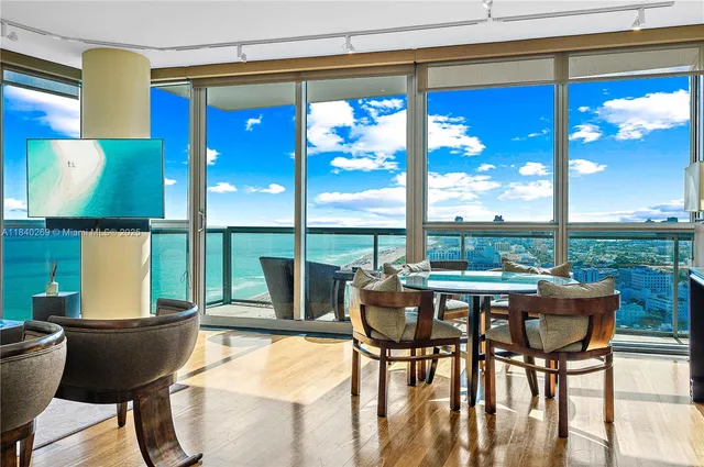 a view of a dining room with furniture window and outside view