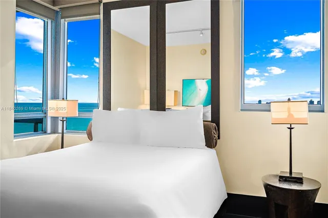 a bedroom with a bed and a lamp