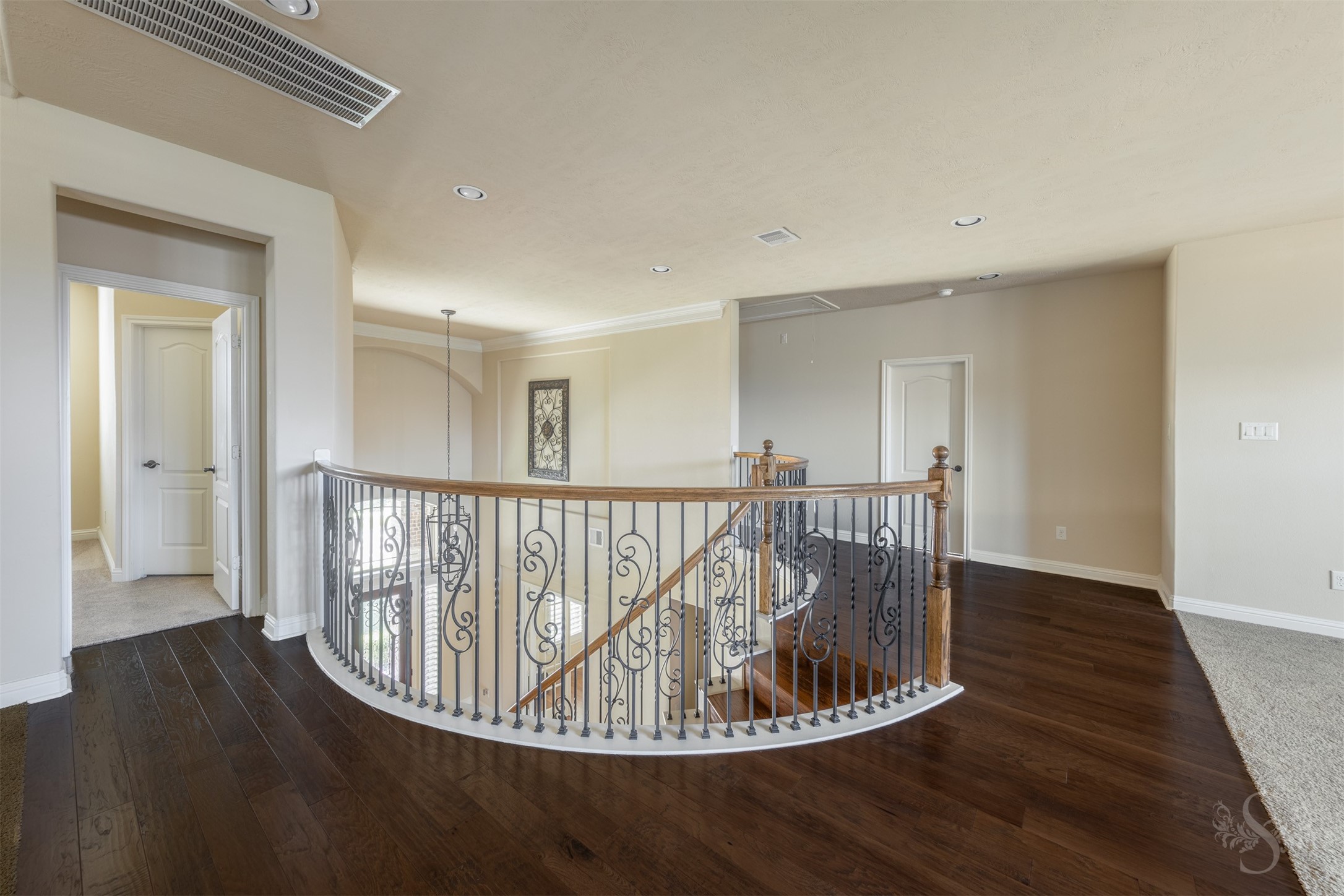 5803 Mustang Ridge Lane Fulshear, TX 77441 - Photo 23 of 48 Open upstairs landing with rich wood flooring and decorative iron railing overlooks the grand 2 story entry below. The spacious layout creates an impressive transition between the upstairs living areas.