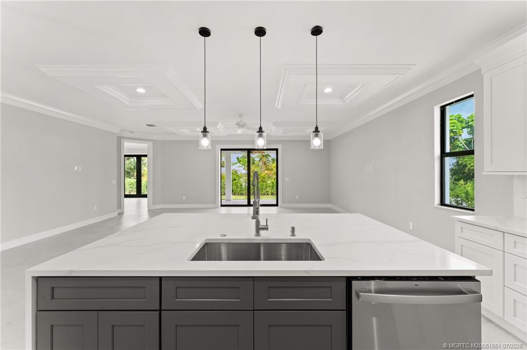 5460 Southeast Front Avenue Stuart, FL 34997 - Photo 11 of 40 a kitchen with a sink a window and wooden floor