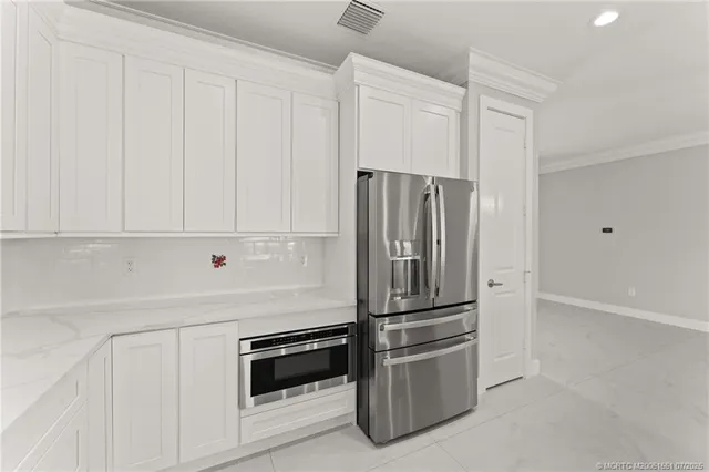 a kitchen with cabinets and stainless steel appliances