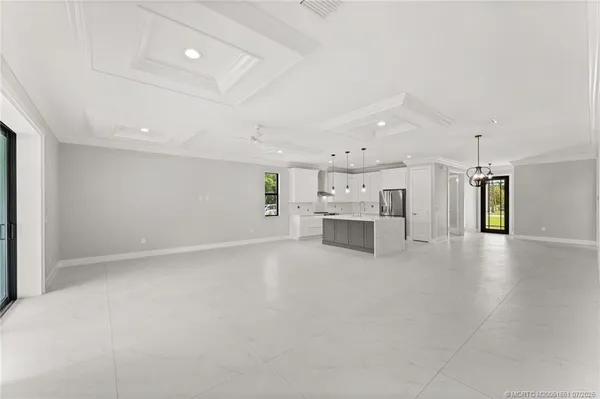 a view of an empty room with a kitchen