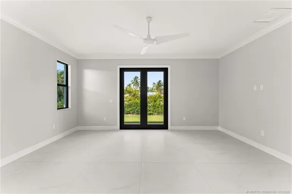 an empty room with windows and closet