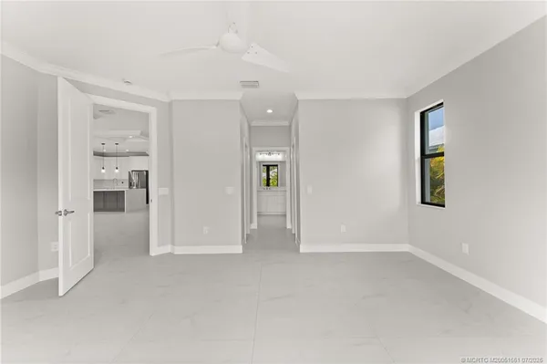 an empty room with windows and closet