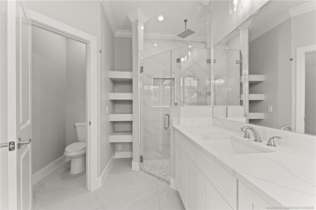 5460 Southeast Front Avenue Stuart, FL 34997 - Photo 22 of 40 a bathroom with a double vanity sink mirror and toilet