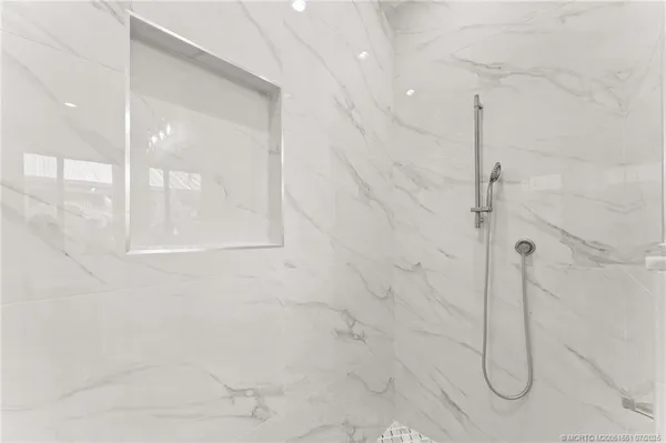 a bathroom with a glass shower door