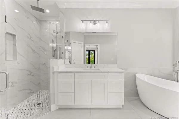 a bathroom with a bathtub a sink and a mirror