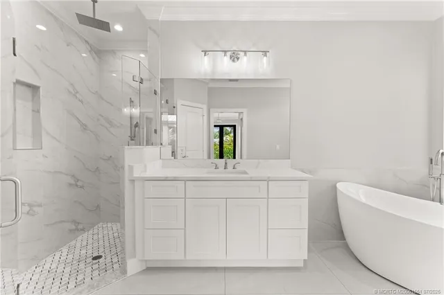 a bathroom with a bathtub a sink and a mirror