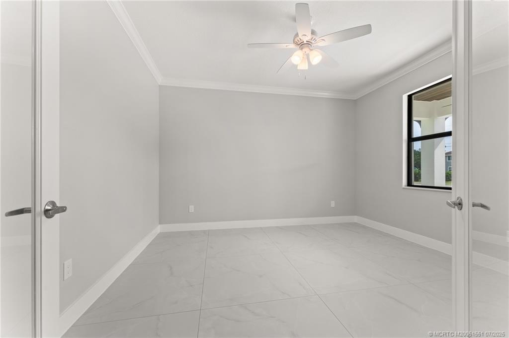 5460 Southeast Front Avenue Stuart, FL 34997 - Photo 26 of 40 an empty room with windows and fan