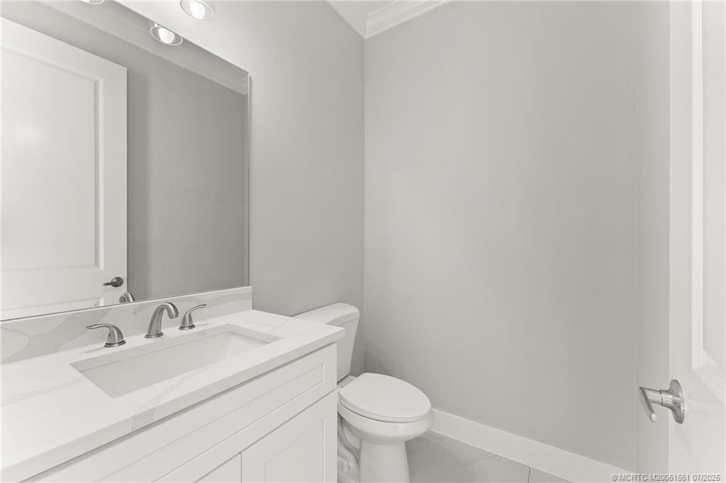 5460 Southeast Front Avenue Stuart, FL 34997 - Photo 29 of 40 a bathroom with a sink toilet and a mirror