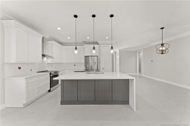 a large kitchen with kitchen island a sink stainless steel appliances and cabinets