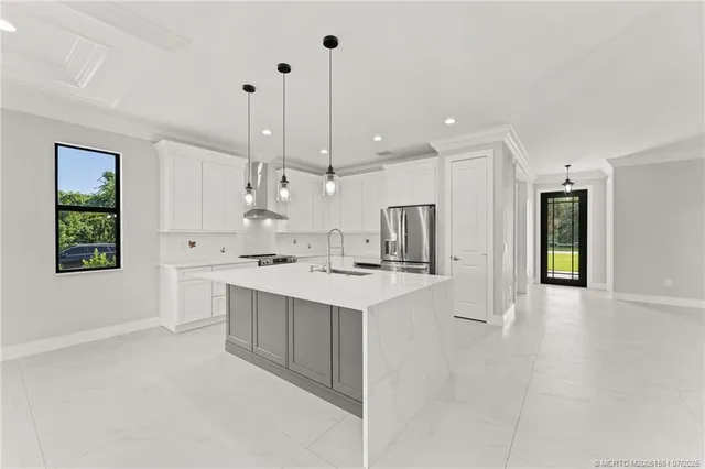 a kitchen with kitchen island a sink stainless steel appliances and cabinets